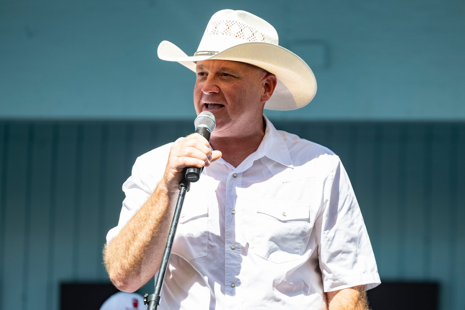 Scott Brummer speaking at an outdoor event